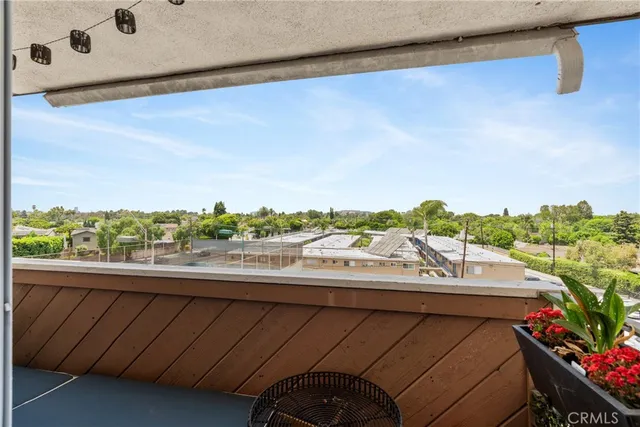 a view of a balcony with chair and a potted plant