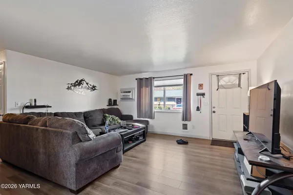 a living room with furniture window and a flat screen tv