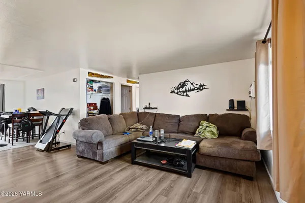 a living room with furniture and wooden floor