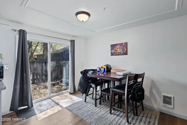 a view of a dining room with furniture and a floor to ceiling window