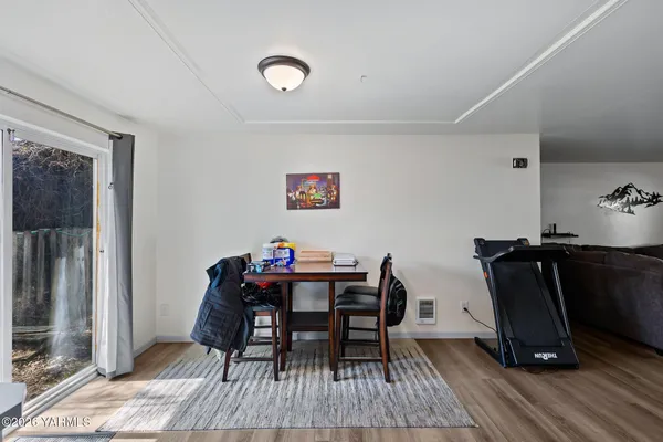 a view of a workspace with furniture and wooden floor