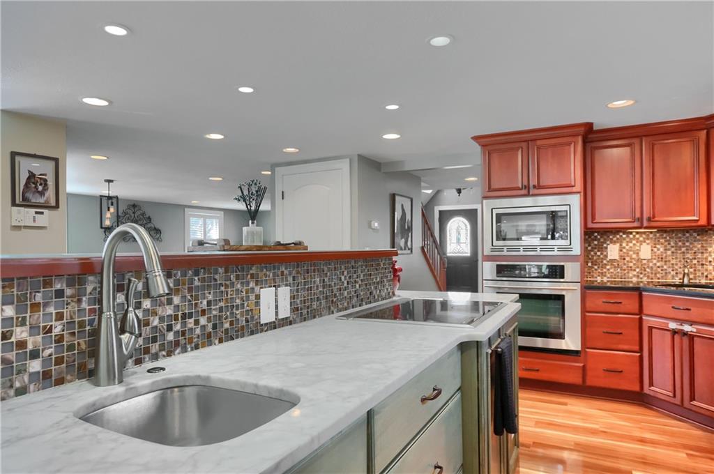 24 Herbst Road Coraopolis, PA 15108 - Photo 16 of 50 a kitchen with stainless steel appliances granite countertop a sink a stove and a refrigerator