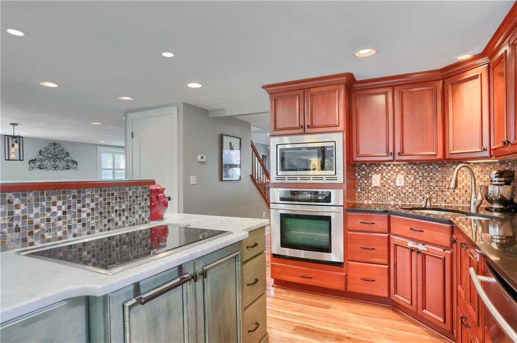 24 Herbst Road Coraopolis, PA 15108 - Photo 18 of 50 a kitchen with stainless steel appliances kitchen island granite countertop a sink and wooden cabinets