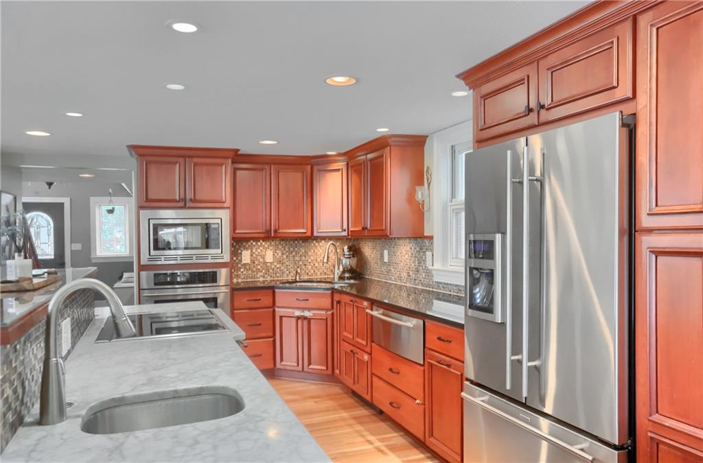 24 Herbst Road Coraopolis, PA 15108 - Photo 20 of 50 a kitchen with stainless steel appliances granite countertop a refrigerator a stove and a sink with wooden floors