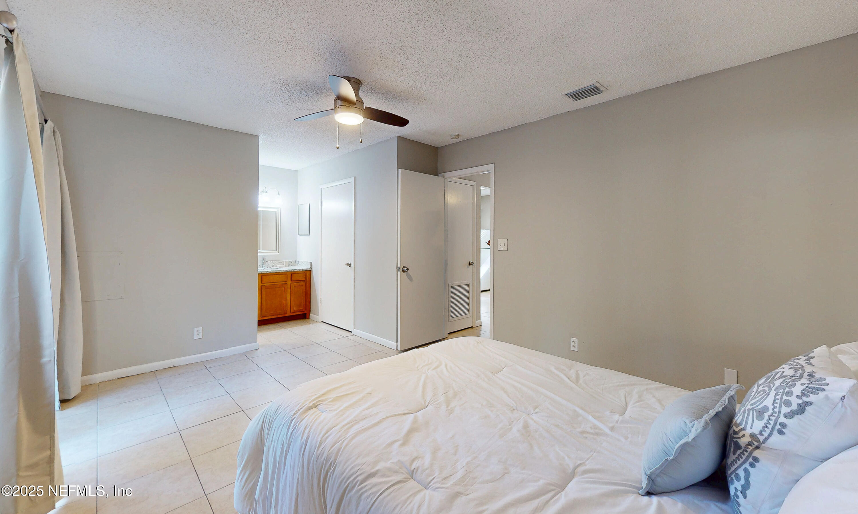 5424 101st Street, Unit 2 Jacksonville, FL 32210 - Photo 7 of 10 a bedroom with a bed and a painting on the wall