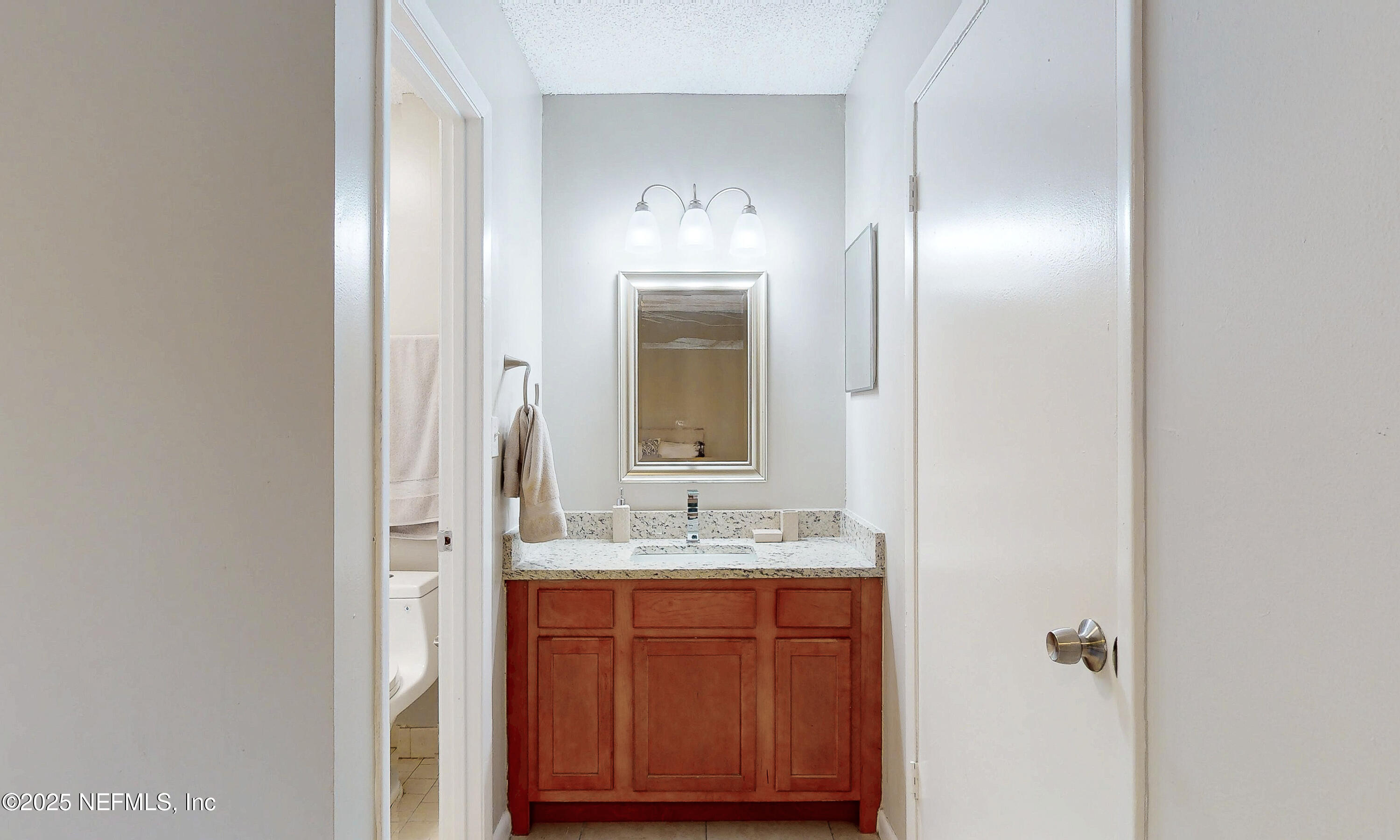 5424 101st Street, Unit 2 Jacksonville, FL 32210 - Photo 8 of 10 a bathroom with a sink and a mirror
