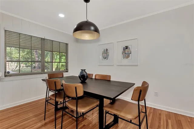 a view of a dining room with furniture wooden floor and chandelier