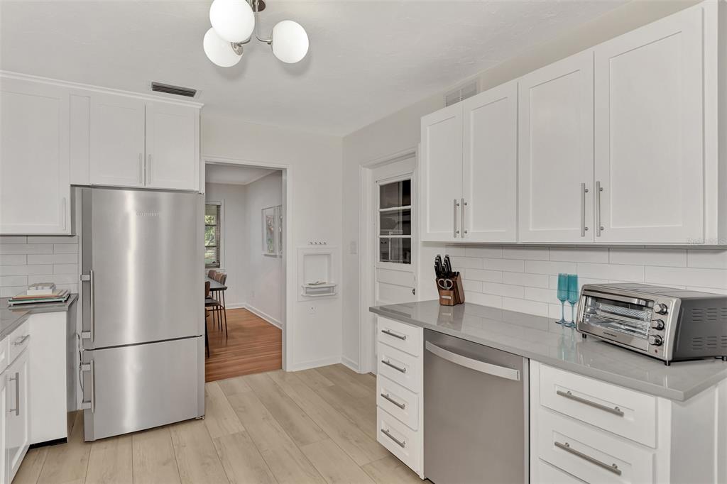 1726 Floyd Street Sarasota, FL 34239 - Photo 17 of 52 a kitchen with stainless steel appliances a refrigerator sink and cabinets