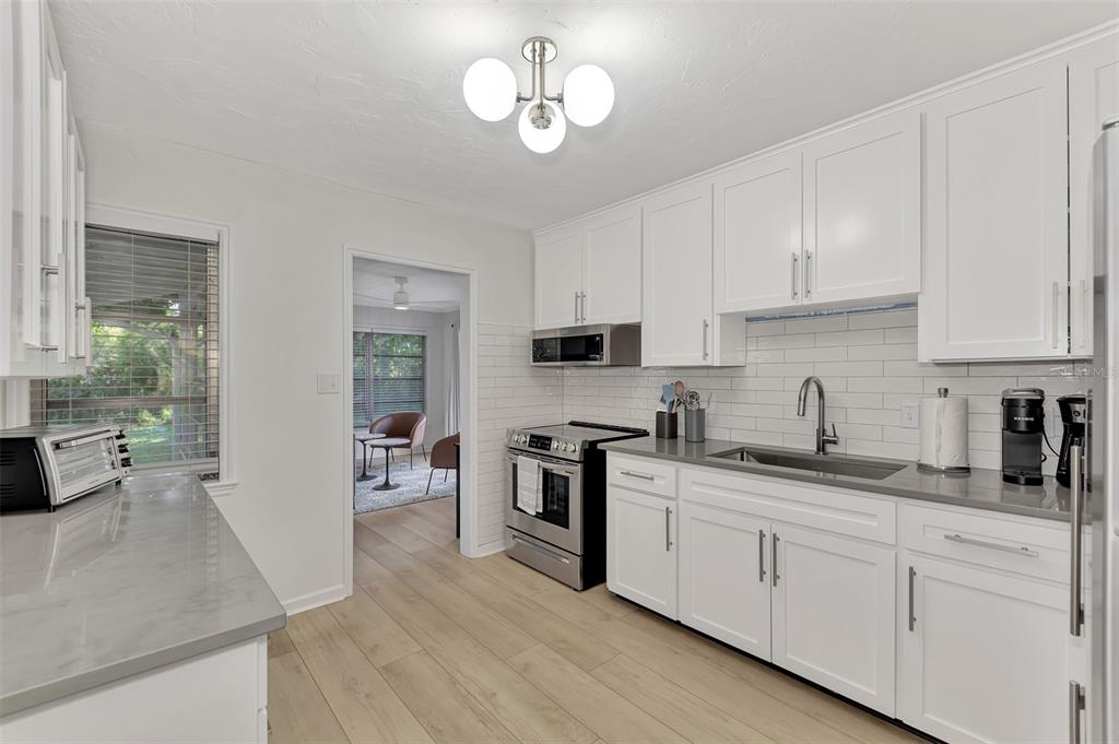 1726 Floyd Street Sarasota, FL 34239 - Photo 19 of 52 a kitchen with stainless steel appliances granite countertop a sink dishwasher stove and refrigerator