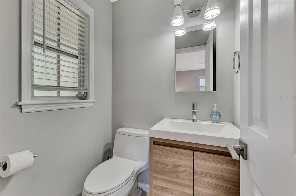 1726 Floyd Street Sarasota, FL 34239 - Photo 27 of 52 a bathroom with a sink vanity mirror and toilet