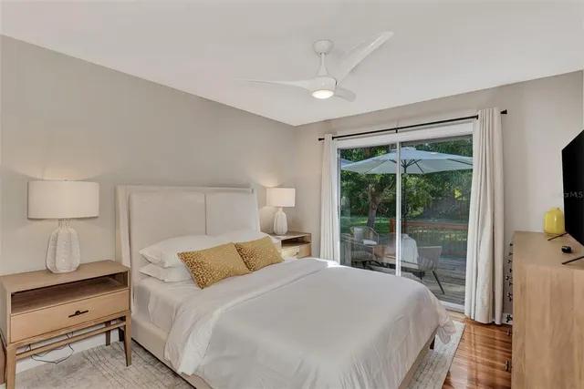 a bedroom with a flat screen tv and a dresser