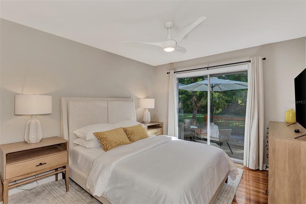 1726 Floyd Street Sarasota, FL 34239 - Photo 28 of 52 a bedroom with a large bed and a flat tv screen on dresser