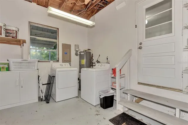 a patio with wooden floor a yard a table and chairs