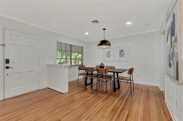 a view of a dining room with furniture and wooden floor