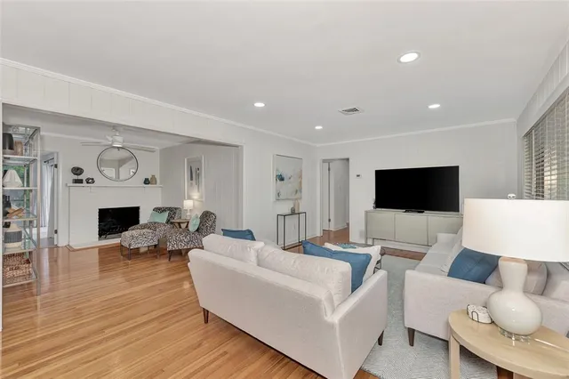 a living room with furniture a fireplace and a flat screen tv