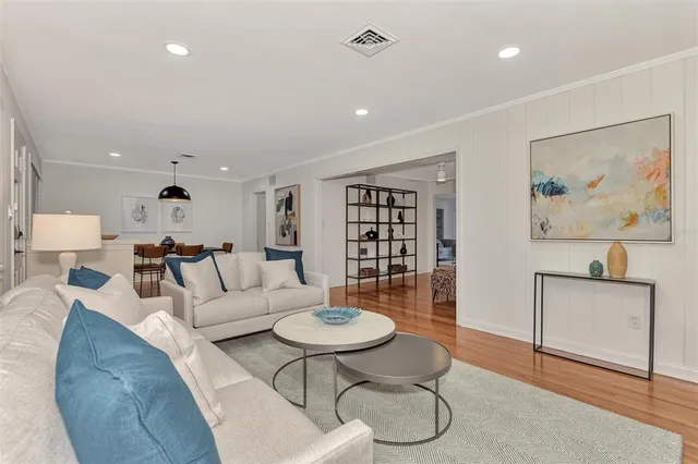 a living room with furniture a rug and a wall painting
