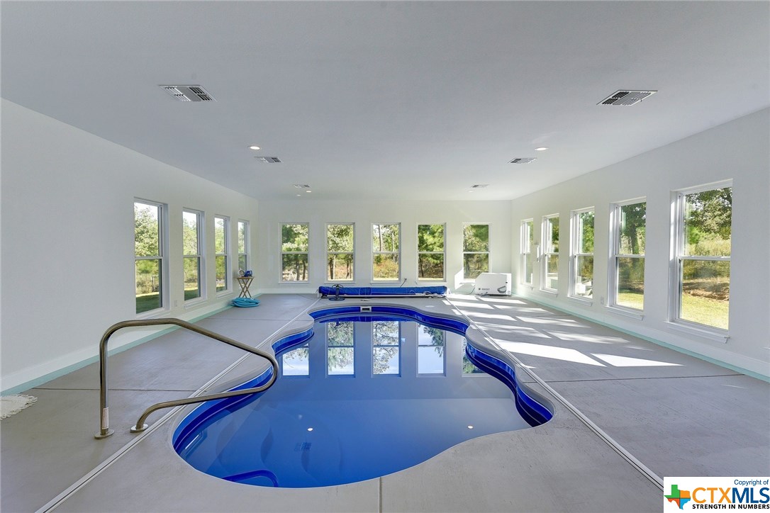 a view of a dining room with furniture large windows and wooden floor