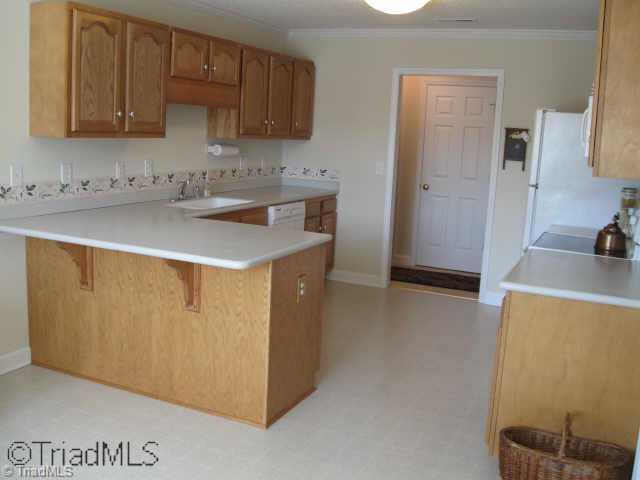 476 Beech Ridge Road Thomasville, NC 27360 - Photo 5 of 9 Other. UPSTAIRS KITCHEN OFFERS CABINETS GALORE. ALSO HAS BREAKFAST NOOK W/ GREAT WINDOWS THAT ALLOW YOU TO LOOK OUT AT IMMACULATE LANDSCAPED BK YD. SEP FORMAL DINNING ROOM.