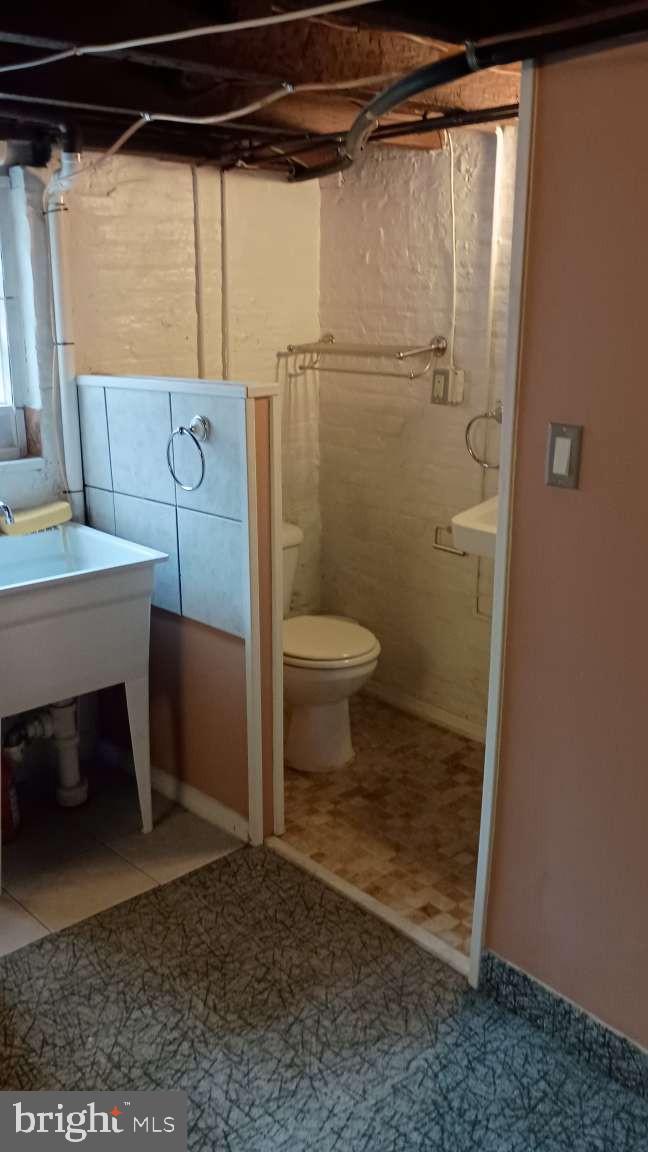 28 South Potomac Street Baltimore, MD 21224 - Photo 20 of 20 a bathroom with a toilet and a shower