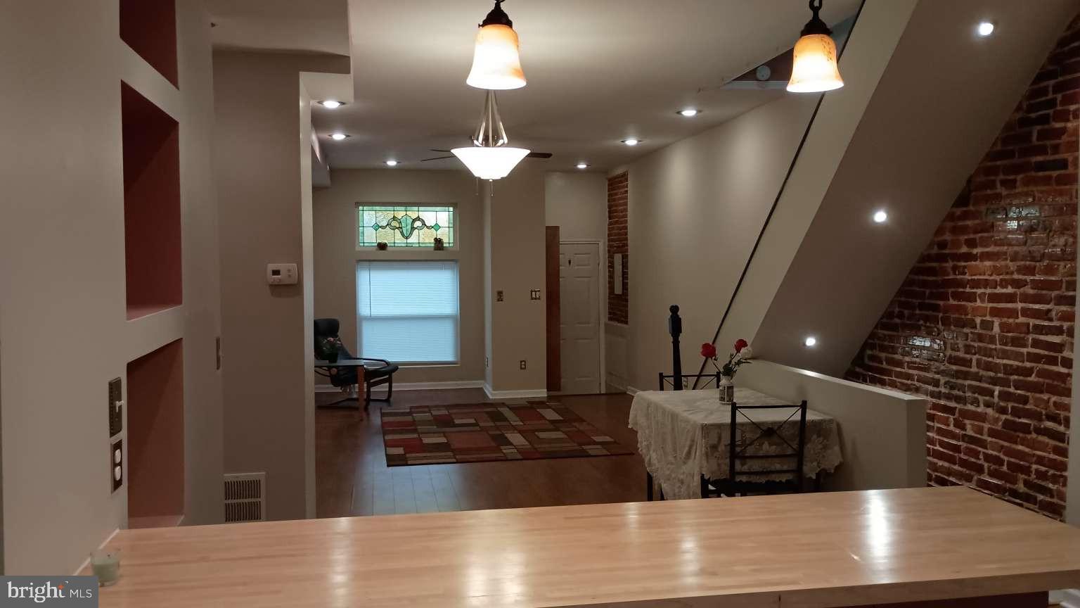 28 South Potomac Street Baltimore, MD 21224 - Photo 9 of 20 a kitchen with kitchen island granite countertop a sink and a stove top oven