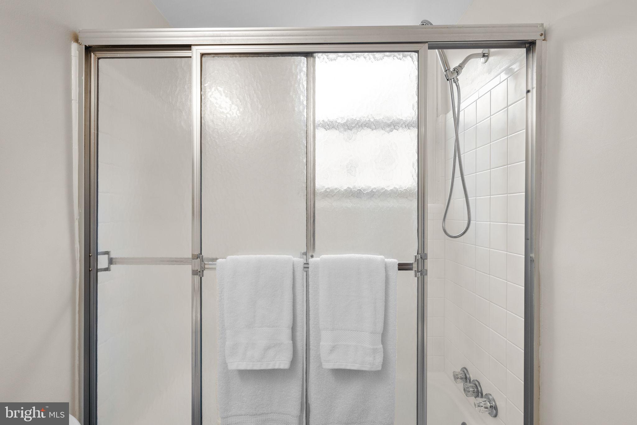 3025 Ontario Road Northwest, Unit 407 Washington, DC 20009 - Photo 22 of 28 Sleek shower with modern elegance.