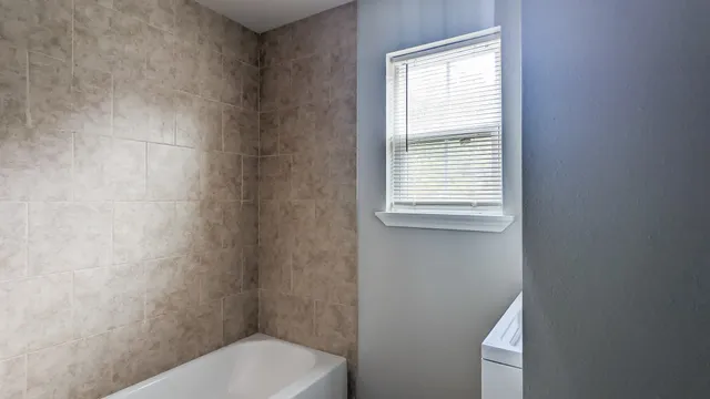 a white toilet sitting next to a window