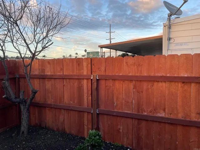 a view of outdoor space with wooden fence