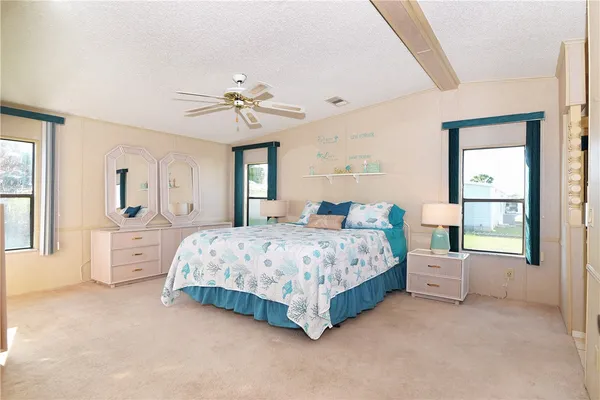 a spacious bedroom with a large bed and windows