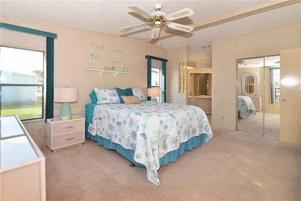 a bedroom with a large bed and a chandelier