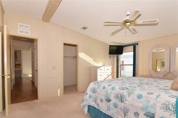 a bedroom with a large bed and a chandelier