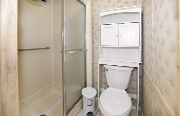 a white toilet sitting next to a bathroom sink