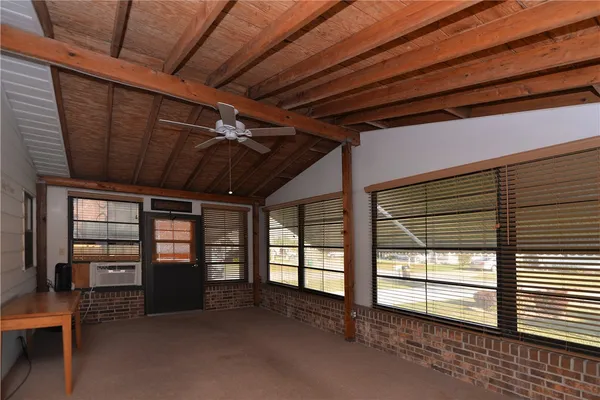 a view of empty room with wooden walls