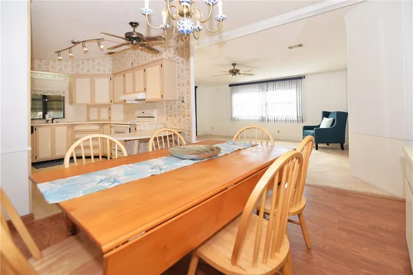 a view of a dining room with furniture and wooden floor