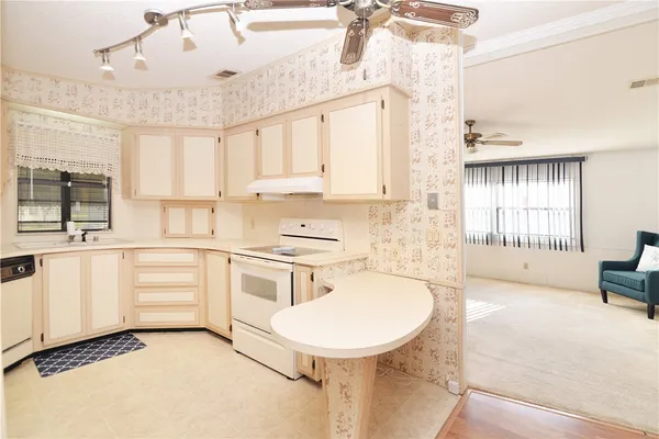 a kitchen with white cabinets and white appliances