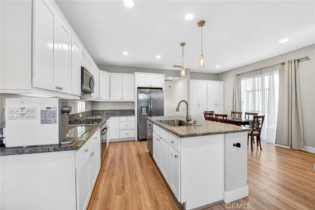 a view of kitchen with cabinets table and chairs