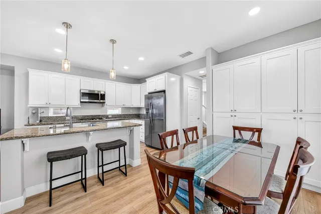 a living room with furniture kitchen view and a window