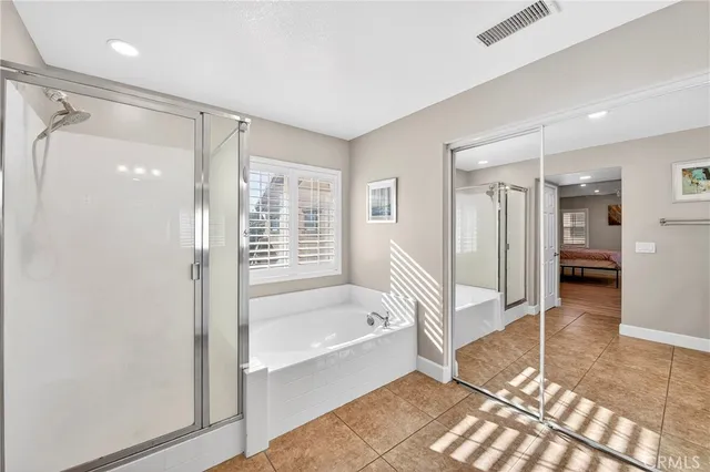 a spacious bedroom with a bed and a window