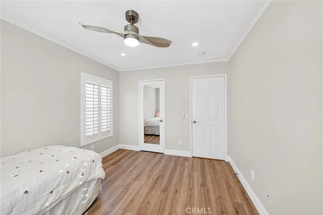 a view of a room with wooden floor and a window