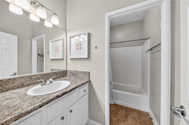 a room with a bed and a chandelier