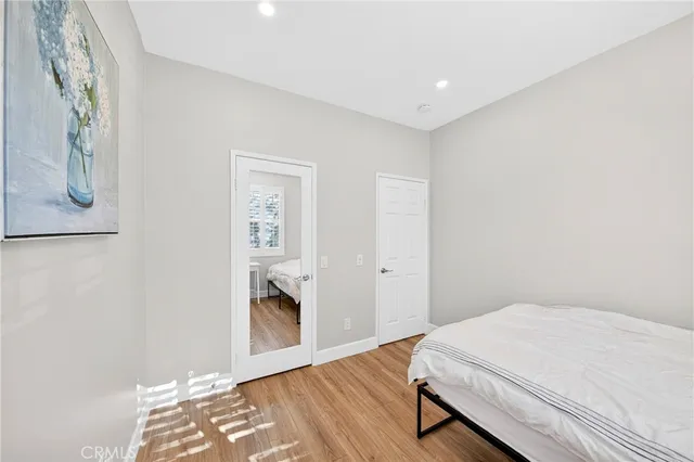 a spacious bedroom with a bed and a table in it