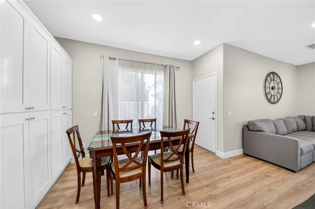 a kitchen with stainless steel appliances granite countertop a stove a refrigerator a oven a sink with a dining table and chairs