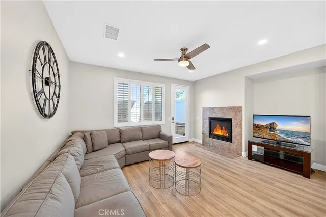 a living room with furniture a clock and a window