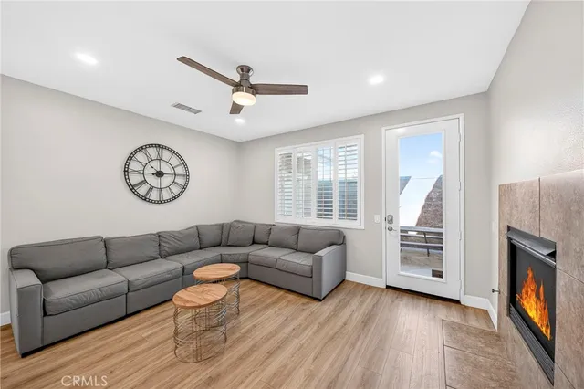 a kitchen with stainless steel appliances granite countertop a stove top oven a sink dishwasher a dining table and chairs with wooden floor