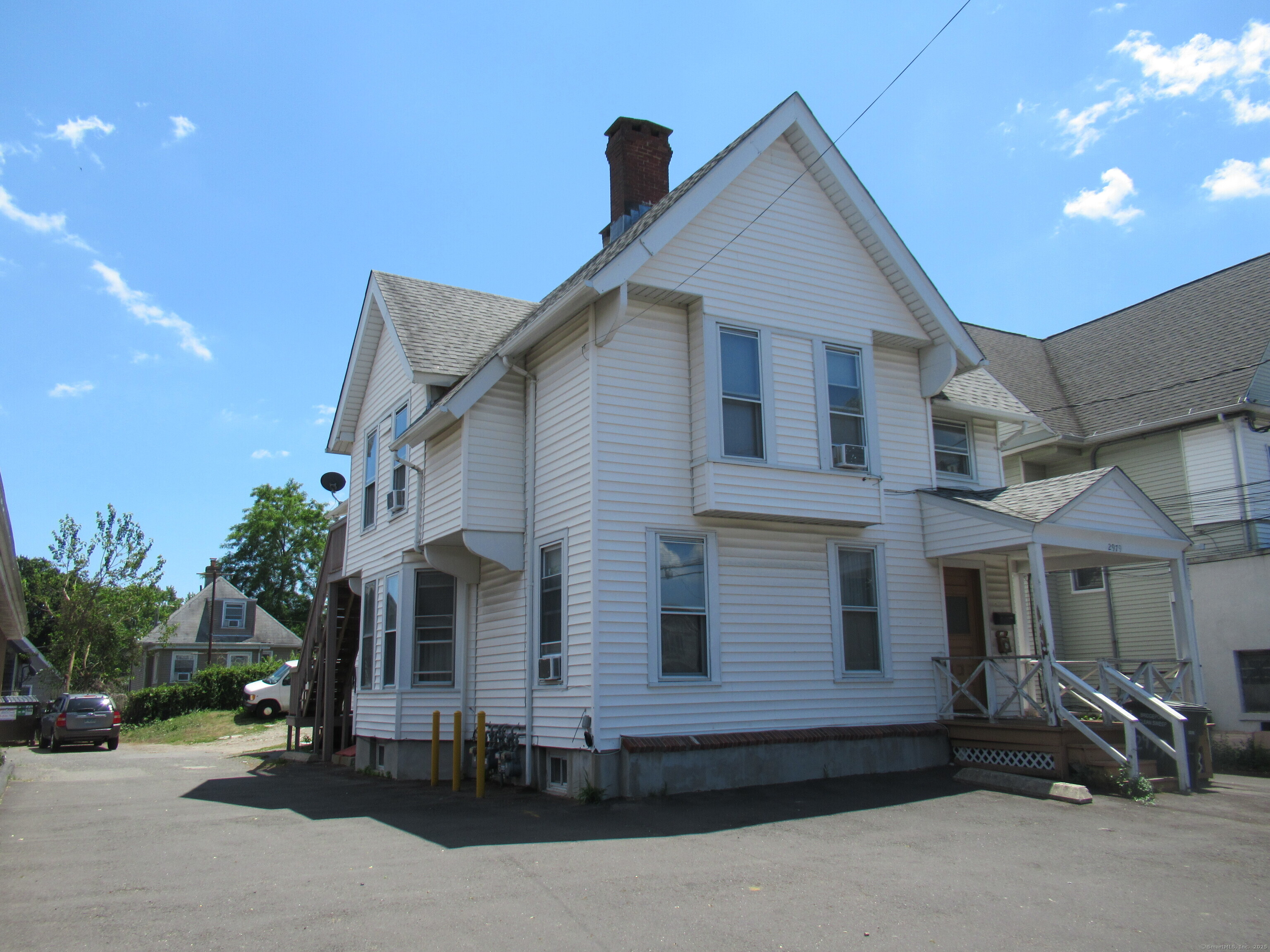 2979 Fairfield Avenue, Unit 1R Bridgeport, CT 06605 - Photo 1 of 13 a front view of a house with a yard