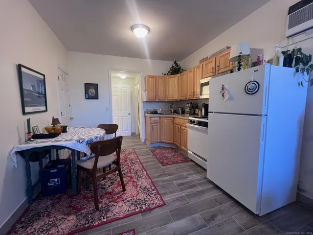 a kitchen with wooden cabinets and refrigerator