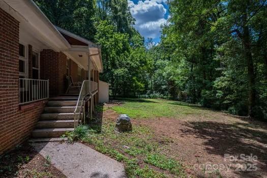 5955 Reepsville Road Vale, NC 28168 - Photo 15 of 48 a view of a yard with plants and wooden fence
