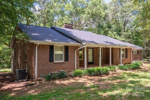 5955 Reepsville Road Vale, NC 28168 - Photo 2 of 48 a view of a brick house with a yard plants and large tree