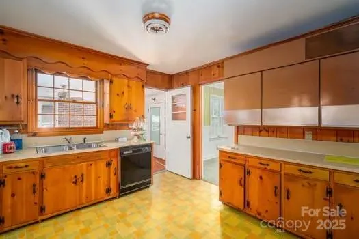 a large kitchen with kitchen island a sink stainless steel appliances and cabinets