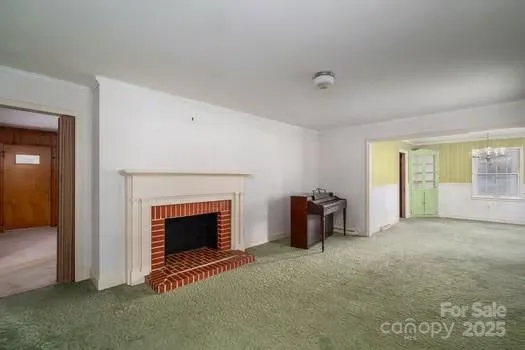 an empty room with furniture and a fireplace