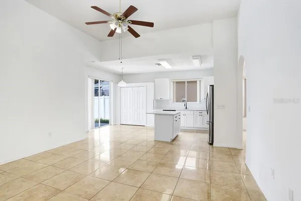 a view of a kitchen with a sink and dishwasher with white walls